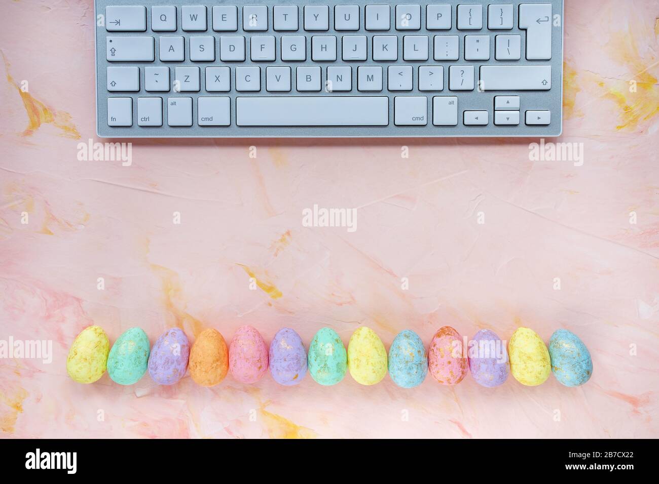 Pastel and gold colored eggs decoration and keyboard computer on pink  background. Easter social media concept. Top view, flat lay, copy space  Stock Photo - Alamy