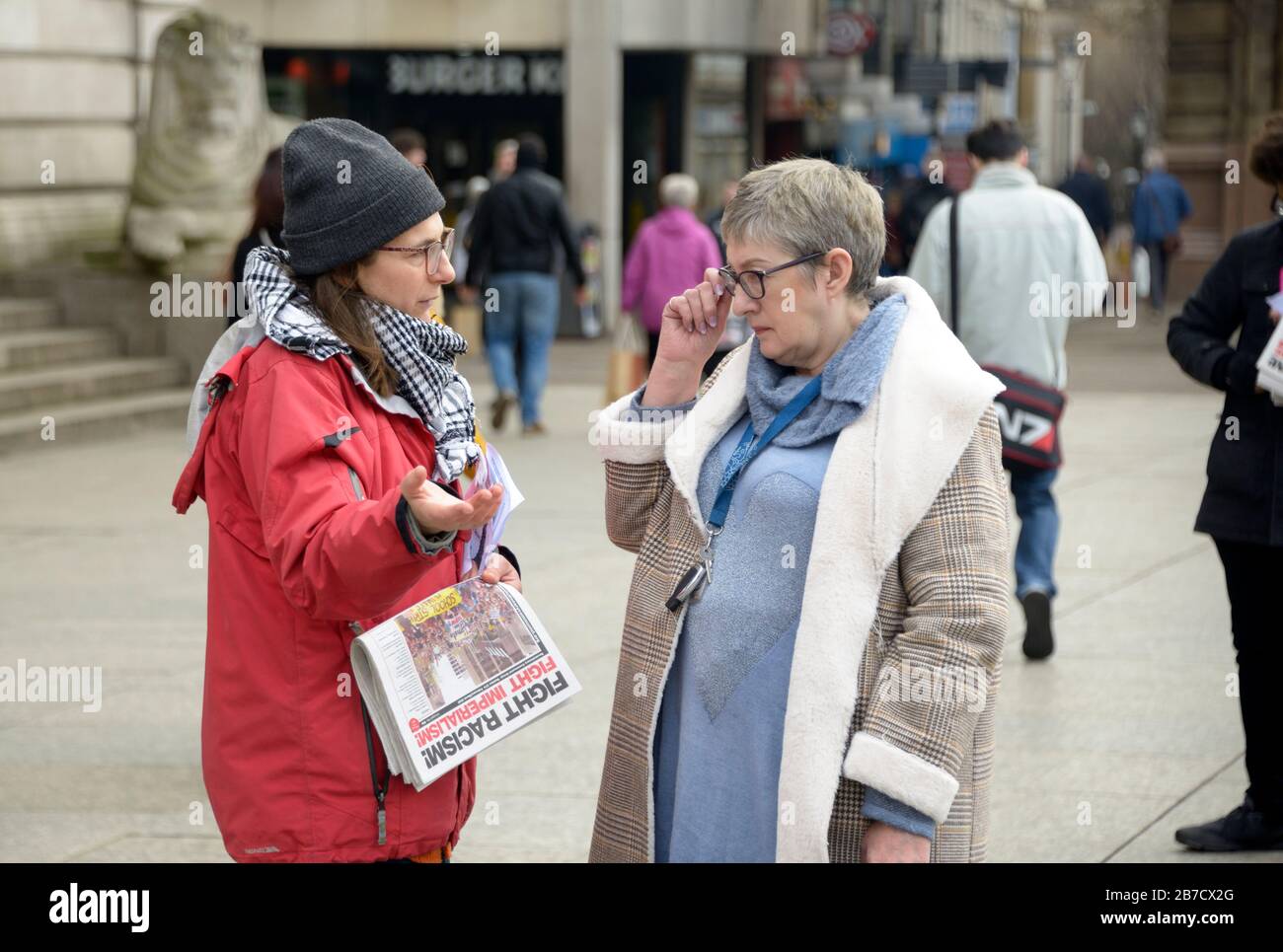 Lady being spoken to by left wing protestor. Stock Photo