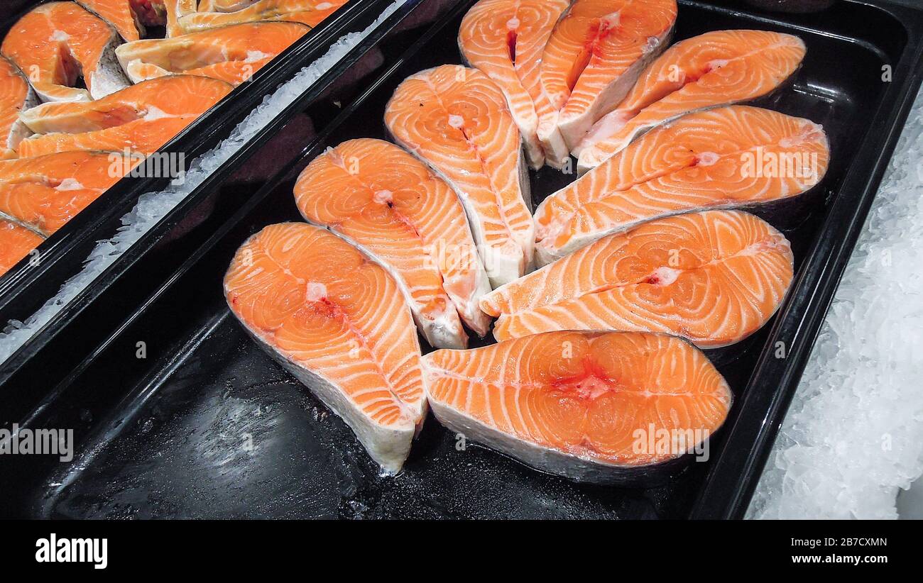 Steaks of fresh salmon on the counter. Raw red fish for sale. Seafood
