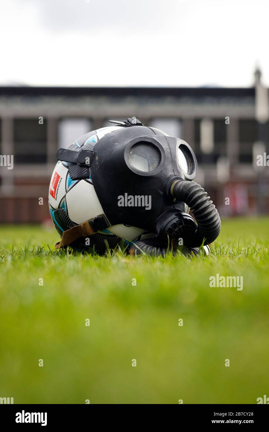 A soccer ball with a gas mask in front of the Rheinenergie Stadium in Cologne (Germany). Stock Photo