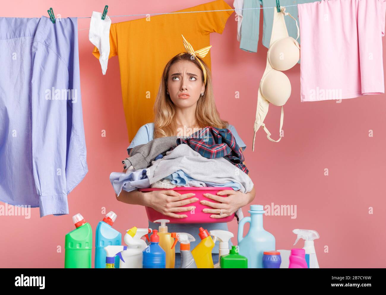 Tired housewife with basin in hands looks at clean clothes Stock Photo Alamy
