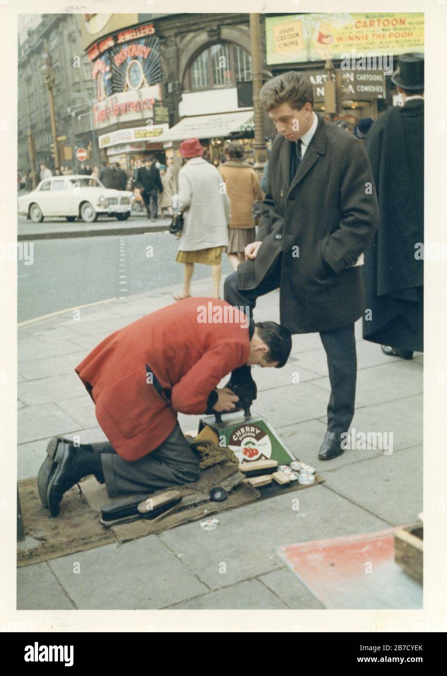 Vintage snapshot image of a young smartly dressed man in a suit having his shoes shined and buffed on the streets of London in the 1960s. Found photo social history vernacular photography UK. Photographer unknown (Richard Bradley collection) Stock Photo