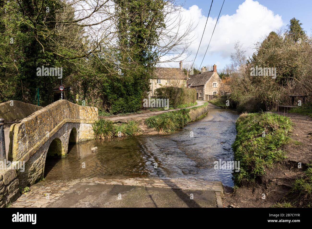 The packhorse bridge over Byde Brook / Bide Brook ford in the picturesque village of Lacock, Wiltshire, England, UK Stock Photo