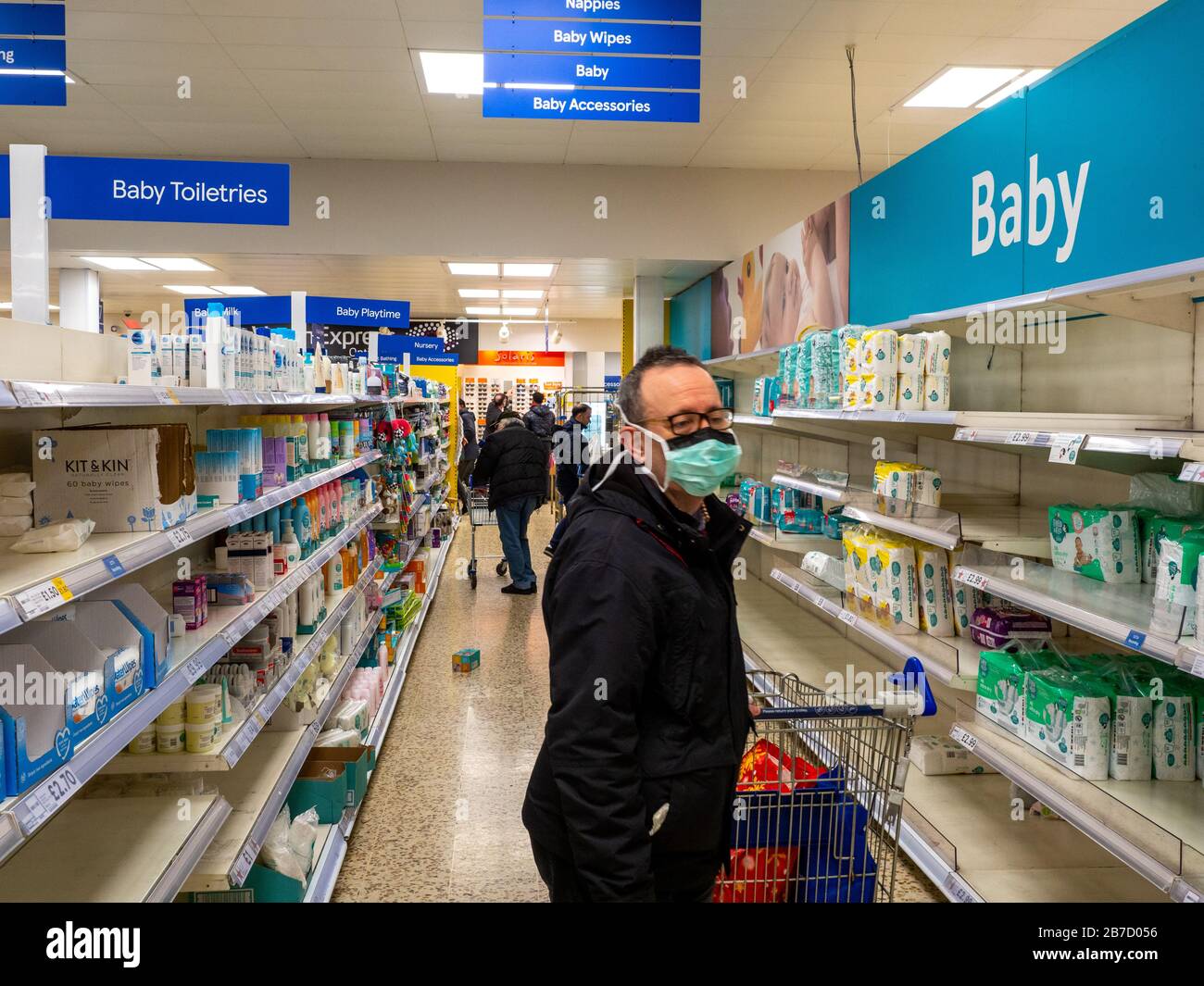 Shpper at Tesco Extra protect themselves from infection by wearing a