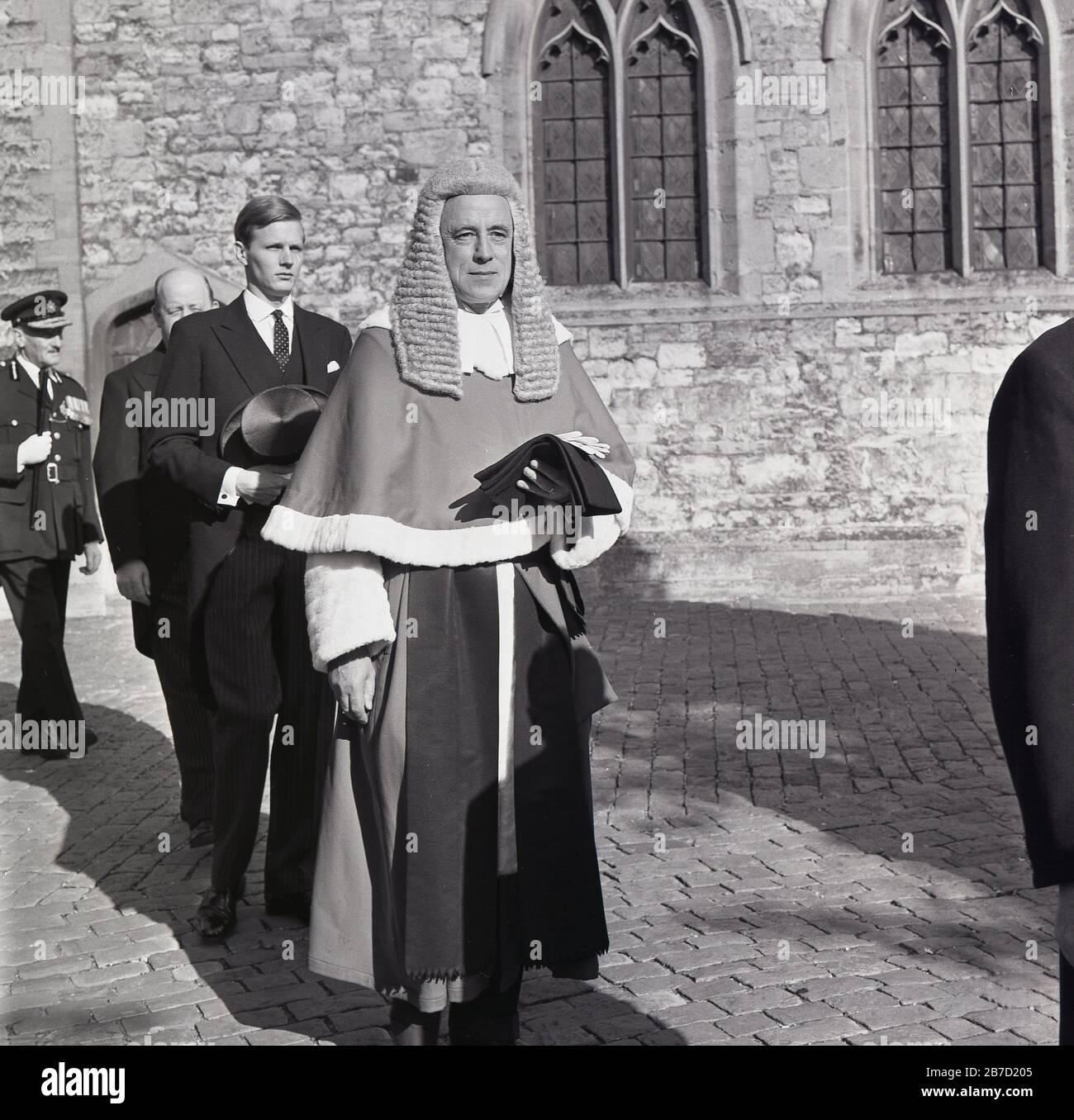 1960s, historical, a male high court judge walking in grounds of church, wearing gown and traditional court headdress, England, UK. Stock Photo