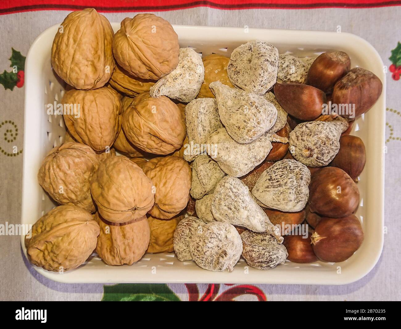 Basket with nuts, walnuts, chestnuts and dried figs Stock Photo