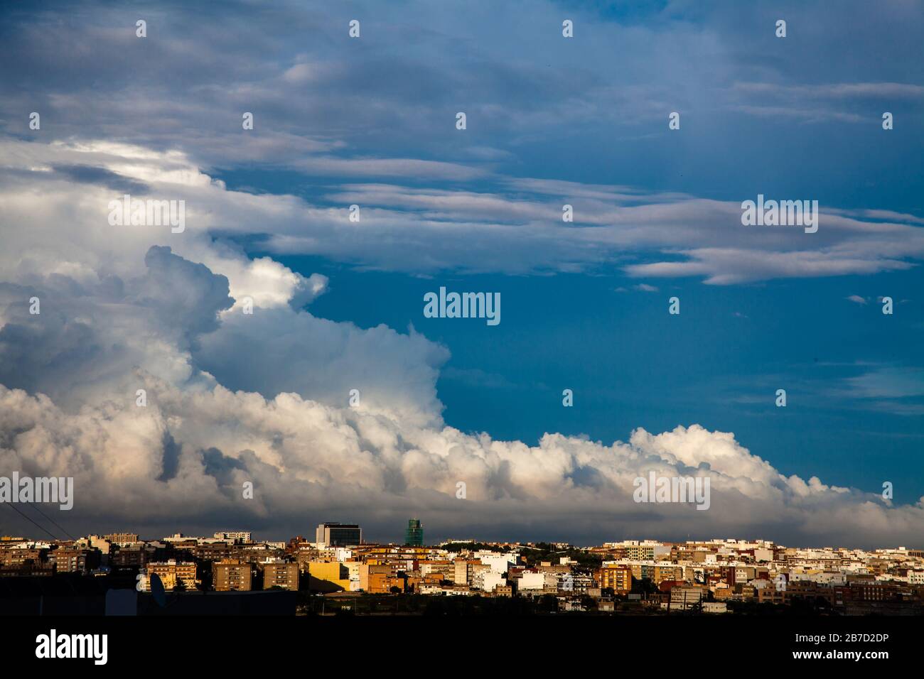 Storm clouds advance over the city and the antennae on the rooftops Stock Photo