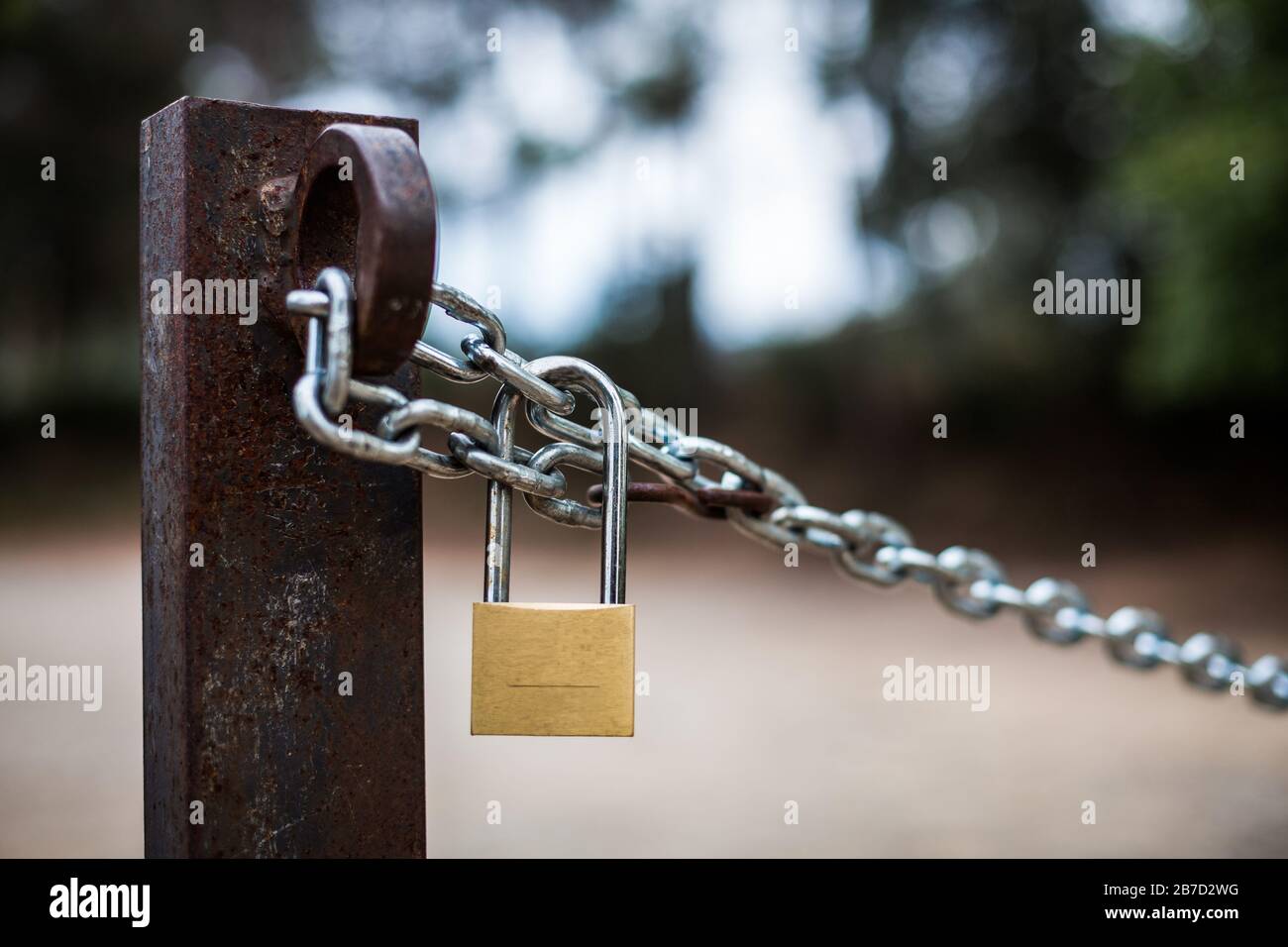 Golden padlock and silver chain in the country Stock Photo