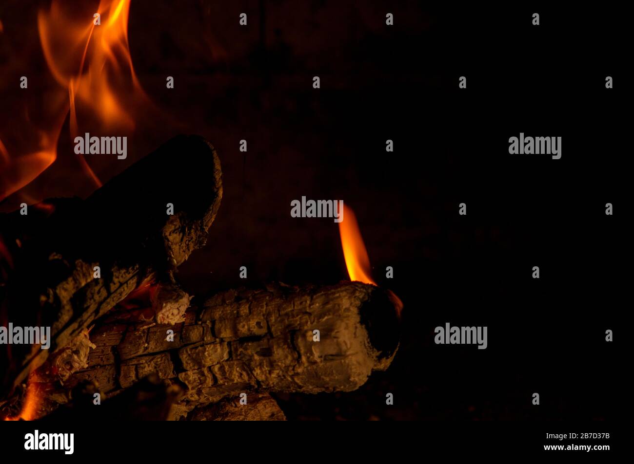 Burning woods with flames in the fireplace Stock Photo - Alamy