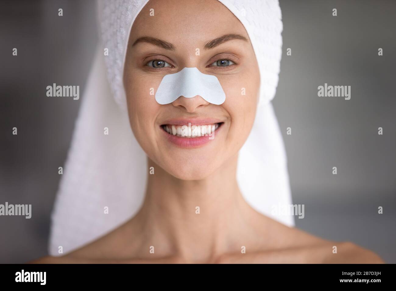 Happy lady with cleansing strip on nose looking at camera. Stock Photo