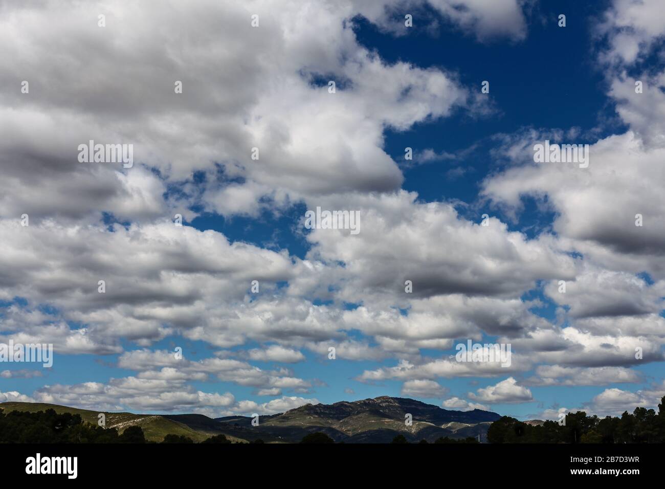 Landscape of mountains and white clouds over blue sky in summer Stock Photo