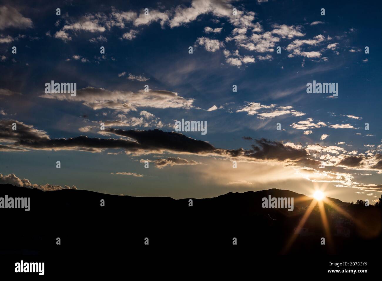 Sunset behind the mountains Stock Photo