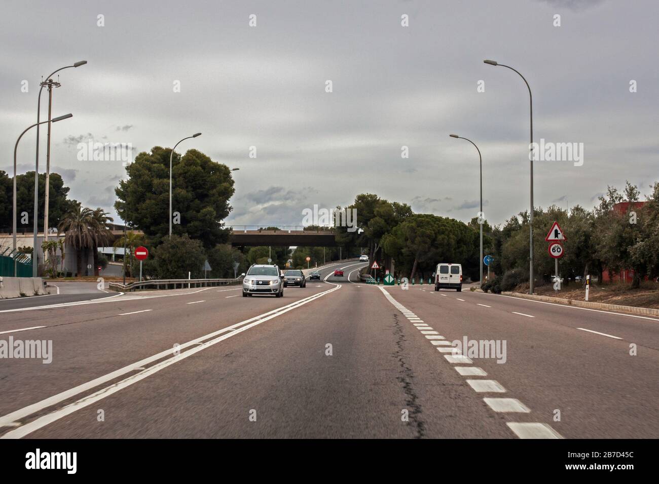 Cars on the road with traffic signs and lines Stock Photo - Alamy