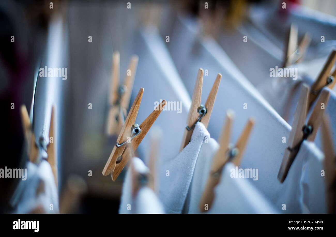 Clothes pegs on the clothesline with cotton white clothes Stock Photo