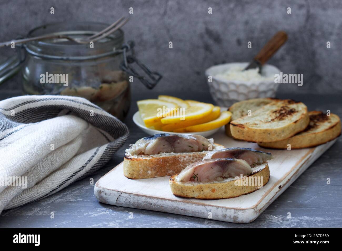 Sandwiches with cottage cheese and gravlax from mackerel, served with