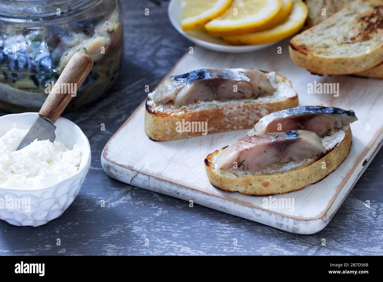 Sandwiches with cottage cheese and gravlax from mackerel, served with