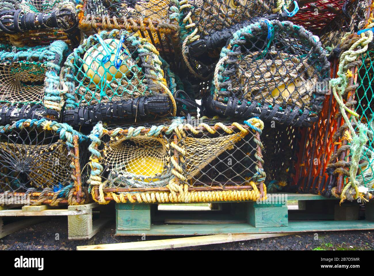 Lobster creels piled up in the harbour at St Abbs, Coldingham, Berwickshire, Scottish Borders, UK Stock Photo