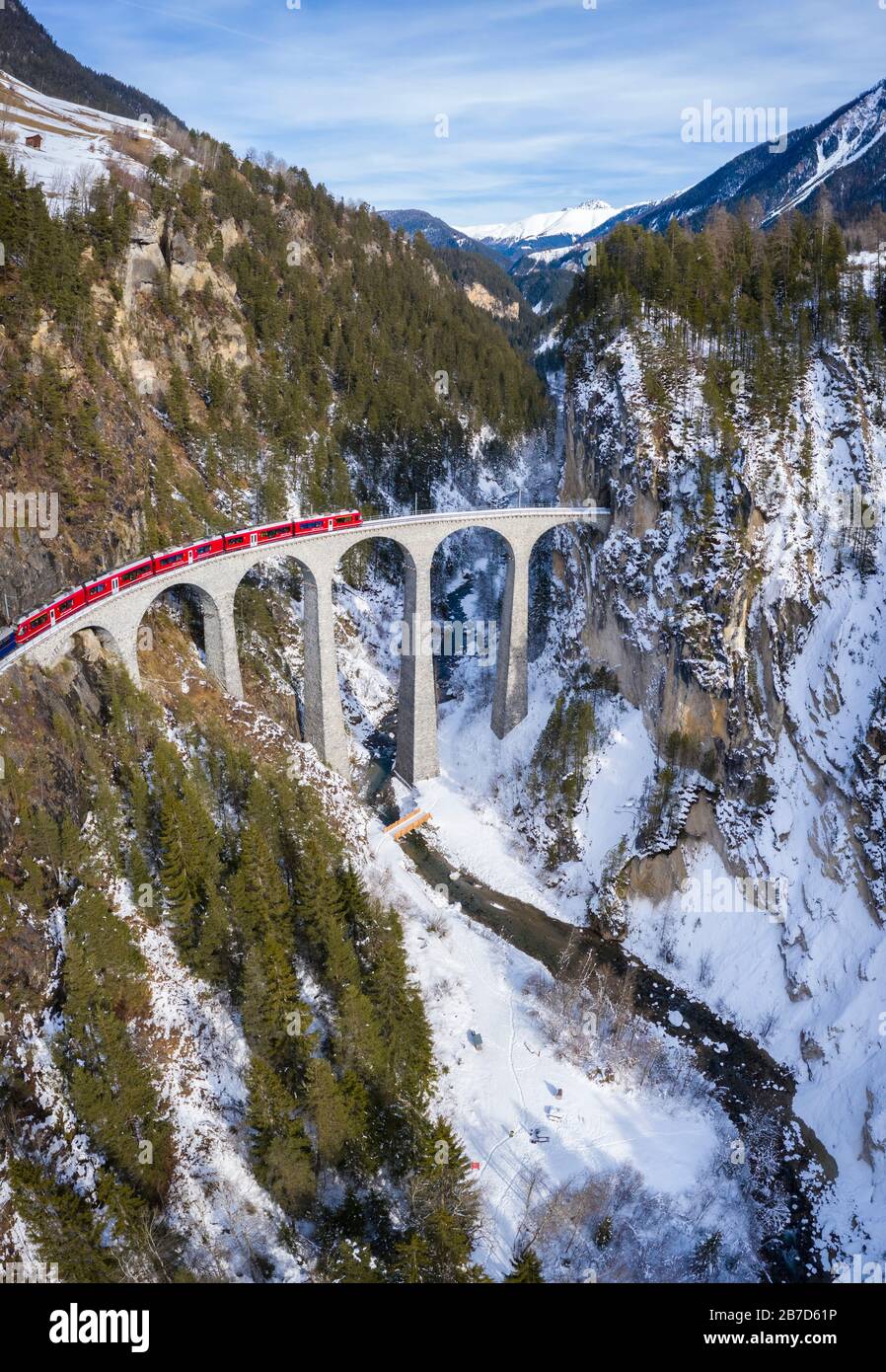 Aerial view of the famous Bernina Express passing over the Landwasser Viaduct. Filisur, Canton of Grisons, Switzerland, Europe. Stock Photo