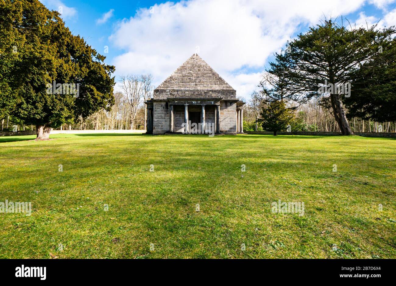 Gosford Estate, East Lothian, Scotland, United Kingdom. 15th March, 2020. UK Weather: Spring sunshine at the country estate. Neo-Classical pyramid burial vault mausoleum built by 7th Earl of Wemyss, Francis Charteris with yew trees Stock Photo