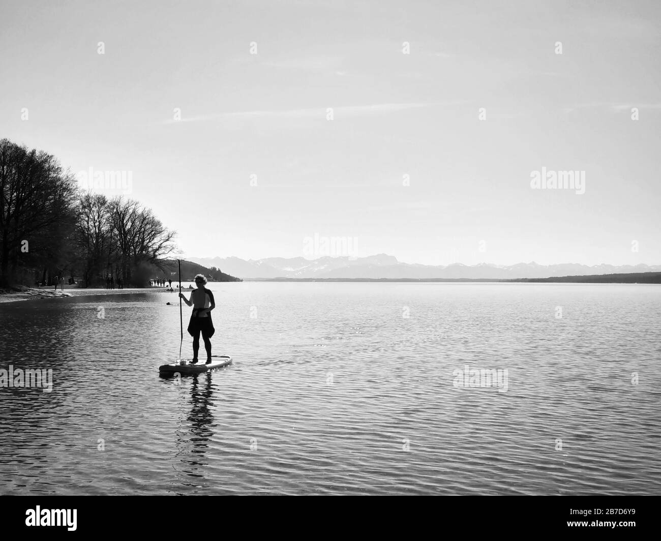 Starnberg, Bavaria, Germany. 15th Mar, 2020. A stand-up paddler on Lake Starnberg near Munich, Germany practices social distancing and flatten the curve during the European Coronavirus outbreak and subsequent measures taken to control the spread. Credit: Sachelle Babbar/ZUMA Wire/Alamy Live News Stock Photo