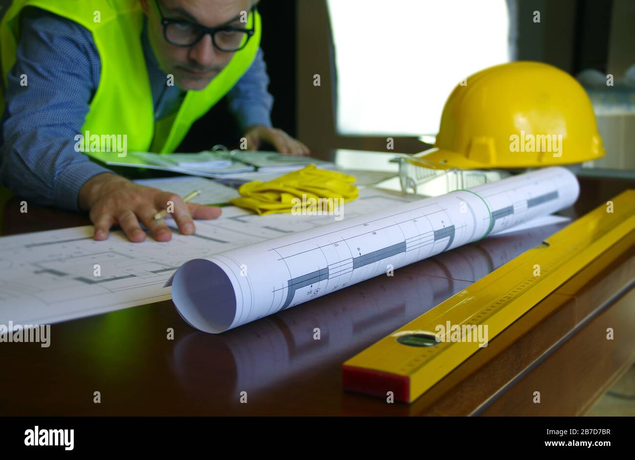 Construction manager, contractor, builder or engineer in workplace. Working man over building sketch. Architecture, engineering and industry concept. Stock Photo