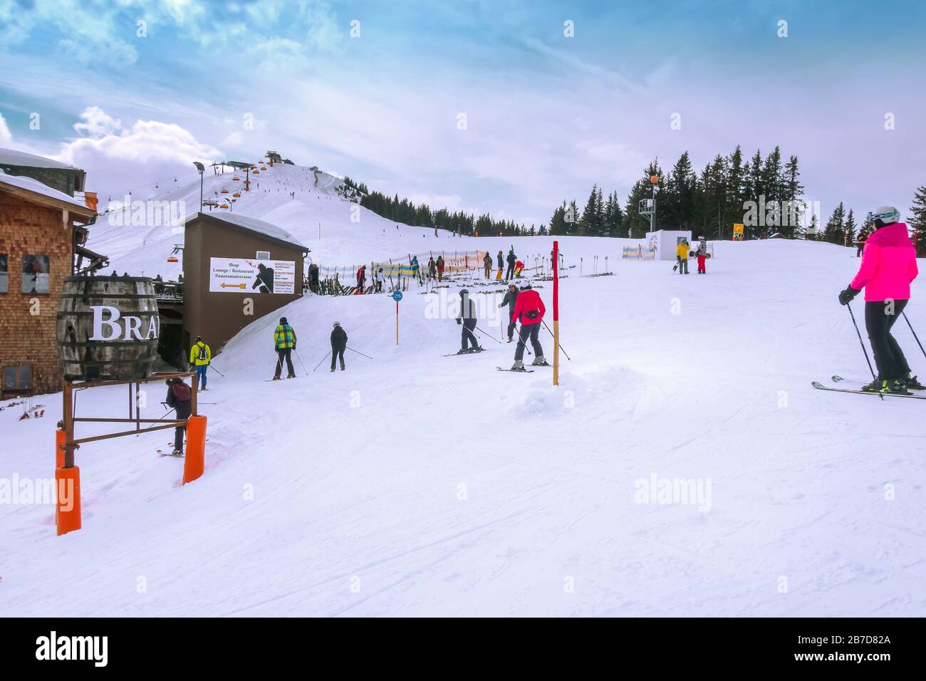 Saalbach-Hinterglemm, Austria - March 2, 2020: People skiing at ski slope and big barrel Stock Photo