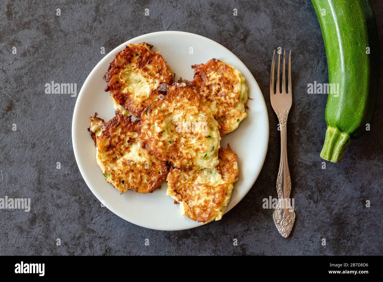 Crispy zucchini fritters with egg, flour and onion Stock Photo Alamy