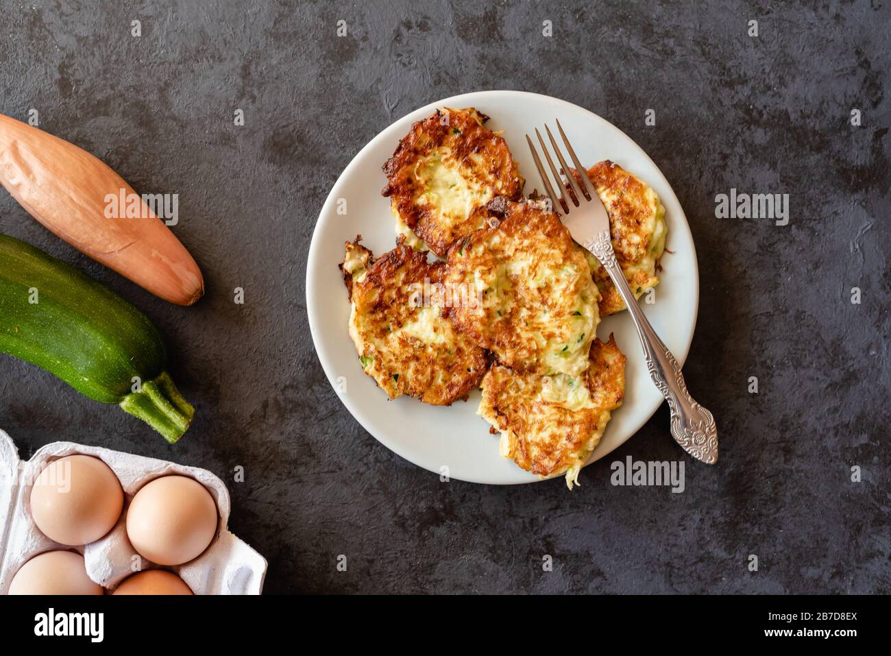 Crispy zucchini fritters with egg, flour and onion Stock Photo Alamy