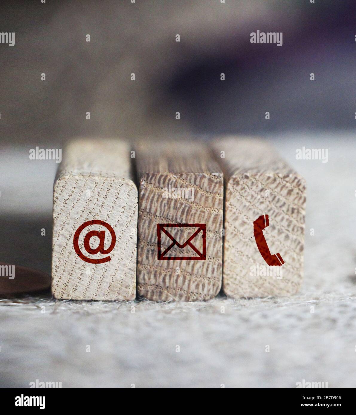 Contact Methods Close-up of email post and phone icons wooden block ...