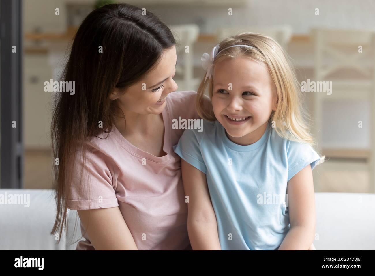 Smiling mom and little daughter enjoy time together Stock Photo
