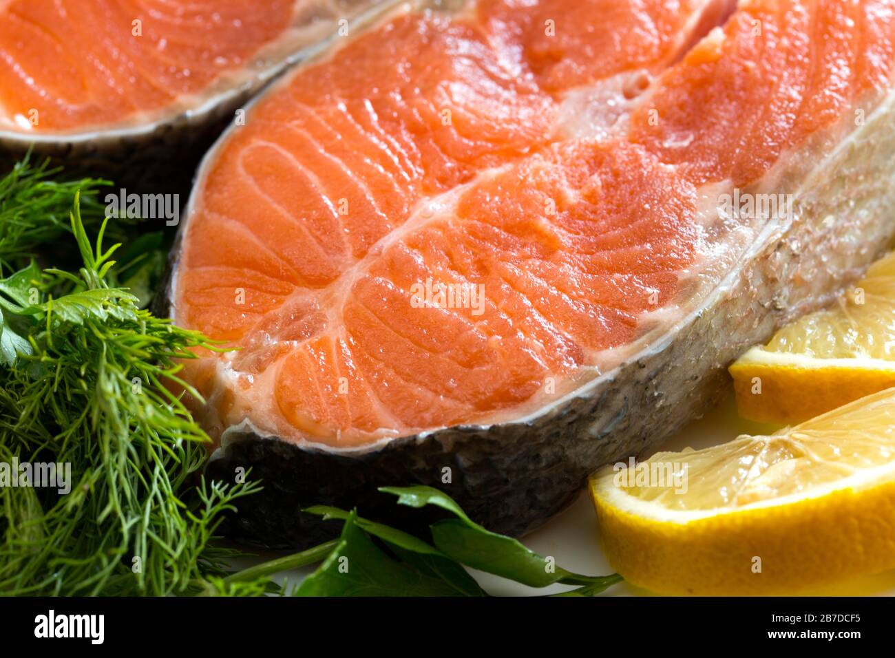 Salmon fish with fresh herbs, lemon and pepper Stock Photo