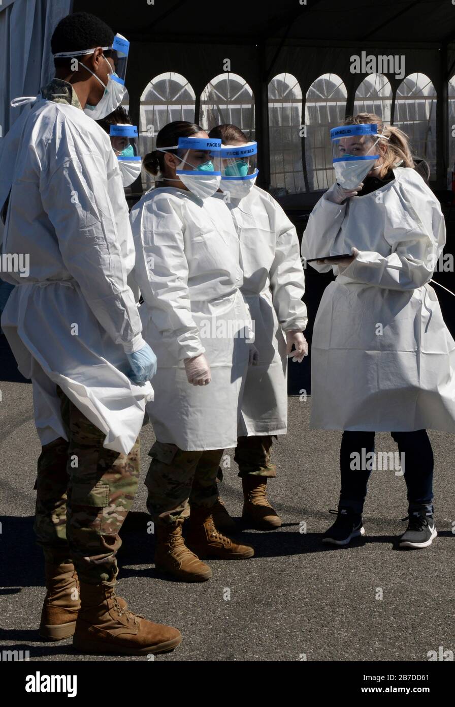 New Rochelle, USA. 14th Mar, 2020. U.S. National Guard members are briefed by a New York State Department of Health administrators on safety protocols after being called up to assist in battling the COVID-19, coronavirus outbreak March 14, 2020 in New Rochelle, New York. Credit: Sean Madden/Planetpix/Alamy Live News Credit: Planetpix/Alamy Live News Stock Photo