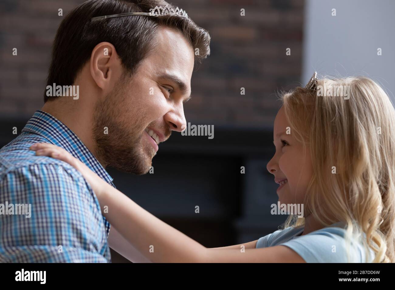 Happy young dad and little girl play girlish game Stock Photo