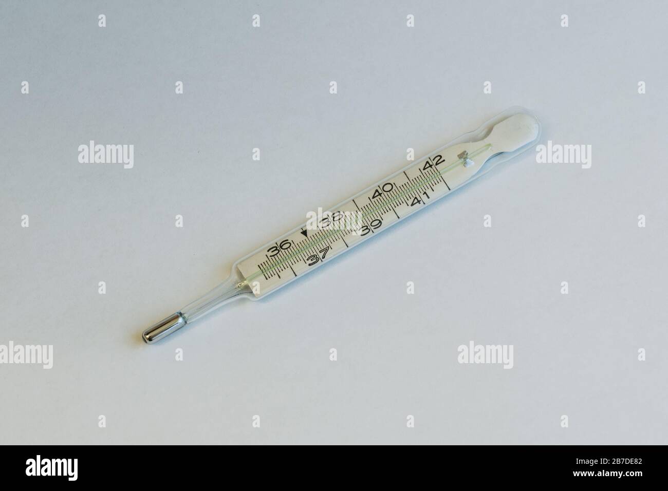 Clinical Fever Thermometer on White Background, a Concept for Illness, Fever, Corona Virus Covid-19 and Healthcare Stock Photo