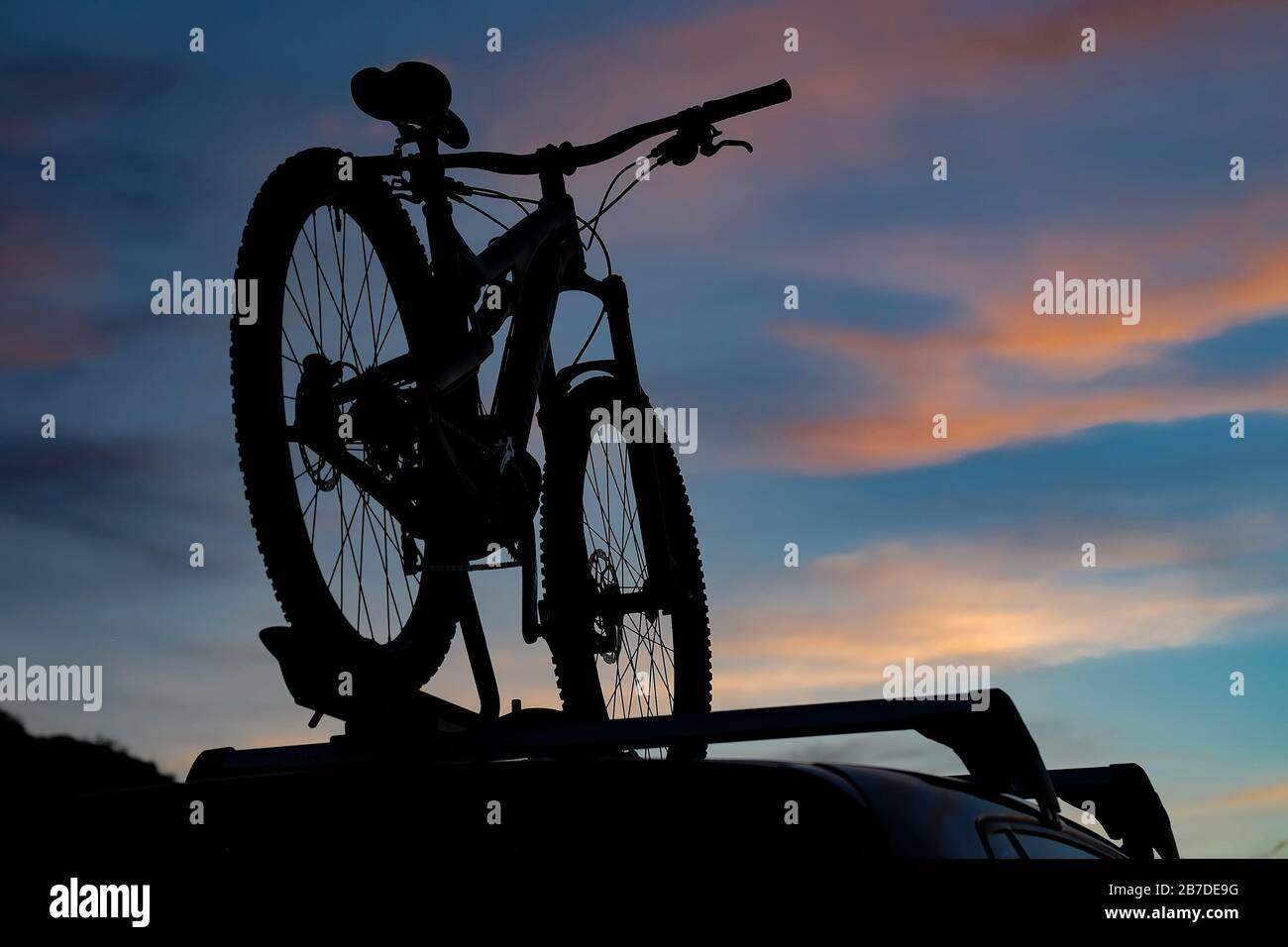 Mountain bike silhouette on a roof rack. Stock Photo