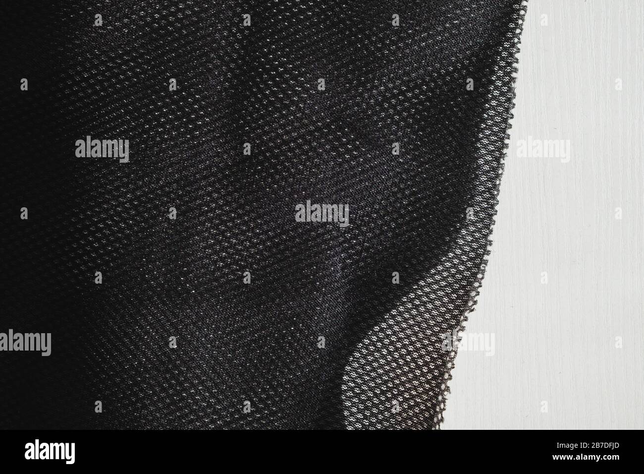 Meshy fabric in white backdrop. Detailed top view of cloth texture Stock Photo