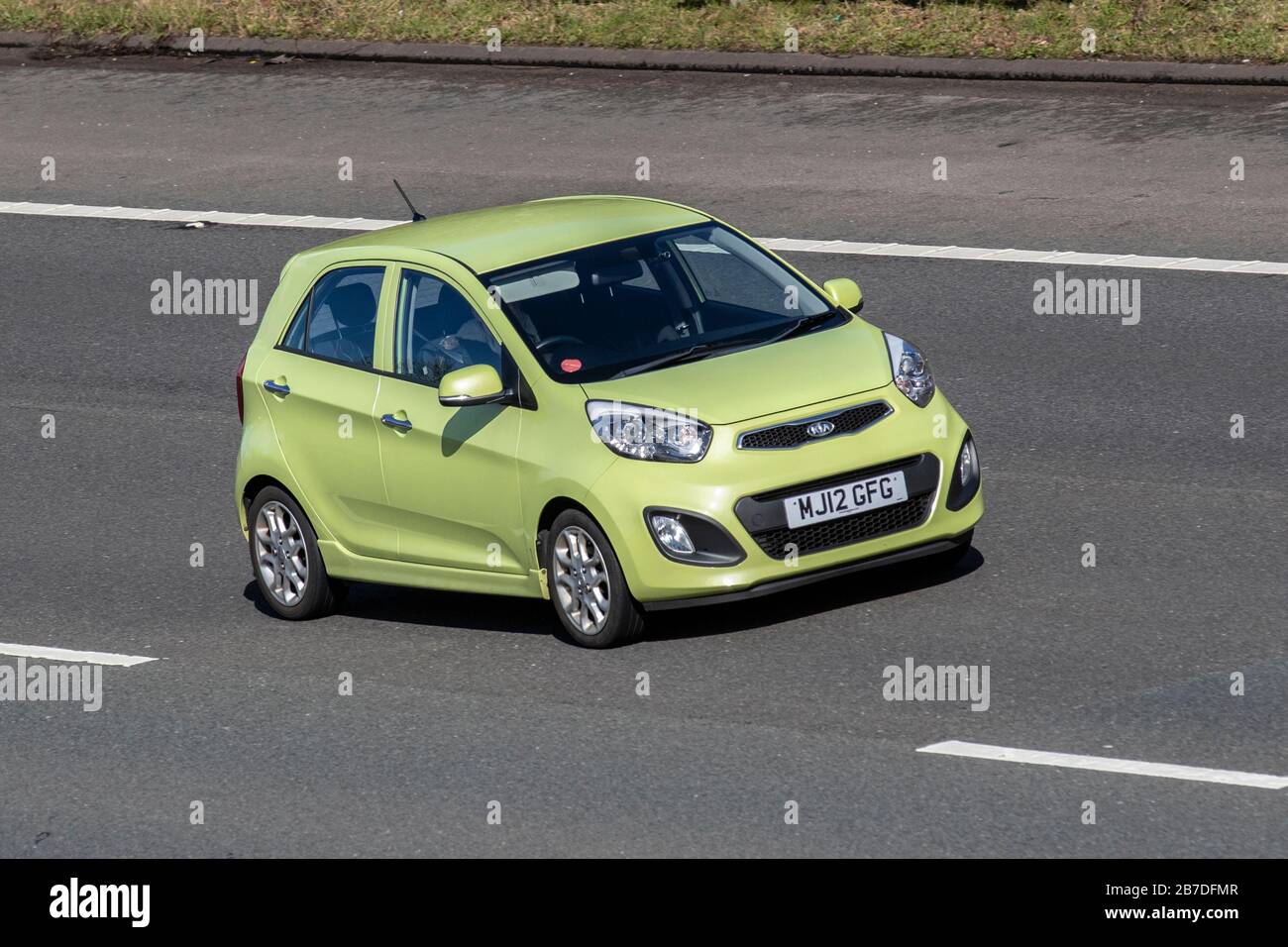 2012 green Kia Picanto 3; Vehicular traffic, transport, modern vehicles, saloon cars, vehicle on UK roads, motors, motoring on the M6 motorway Stock Photo