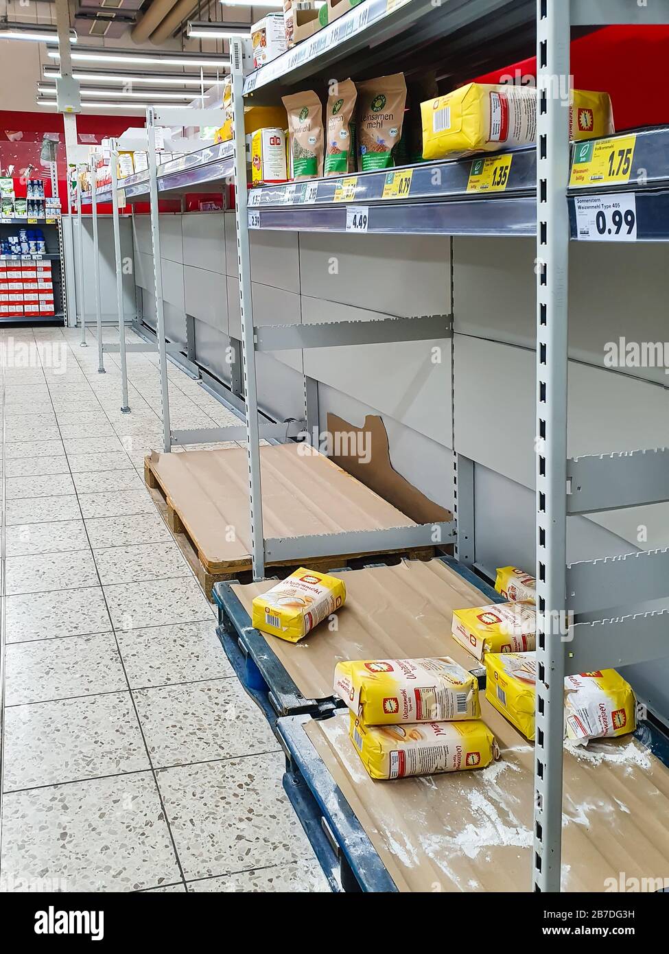 FULDA, GERMANY - MAR 02, 2020: Empty shelves for flour at Kaufland supermarket due to Coronavirus crisis. Panic buying in quarantine leads to food sup Stock Photo