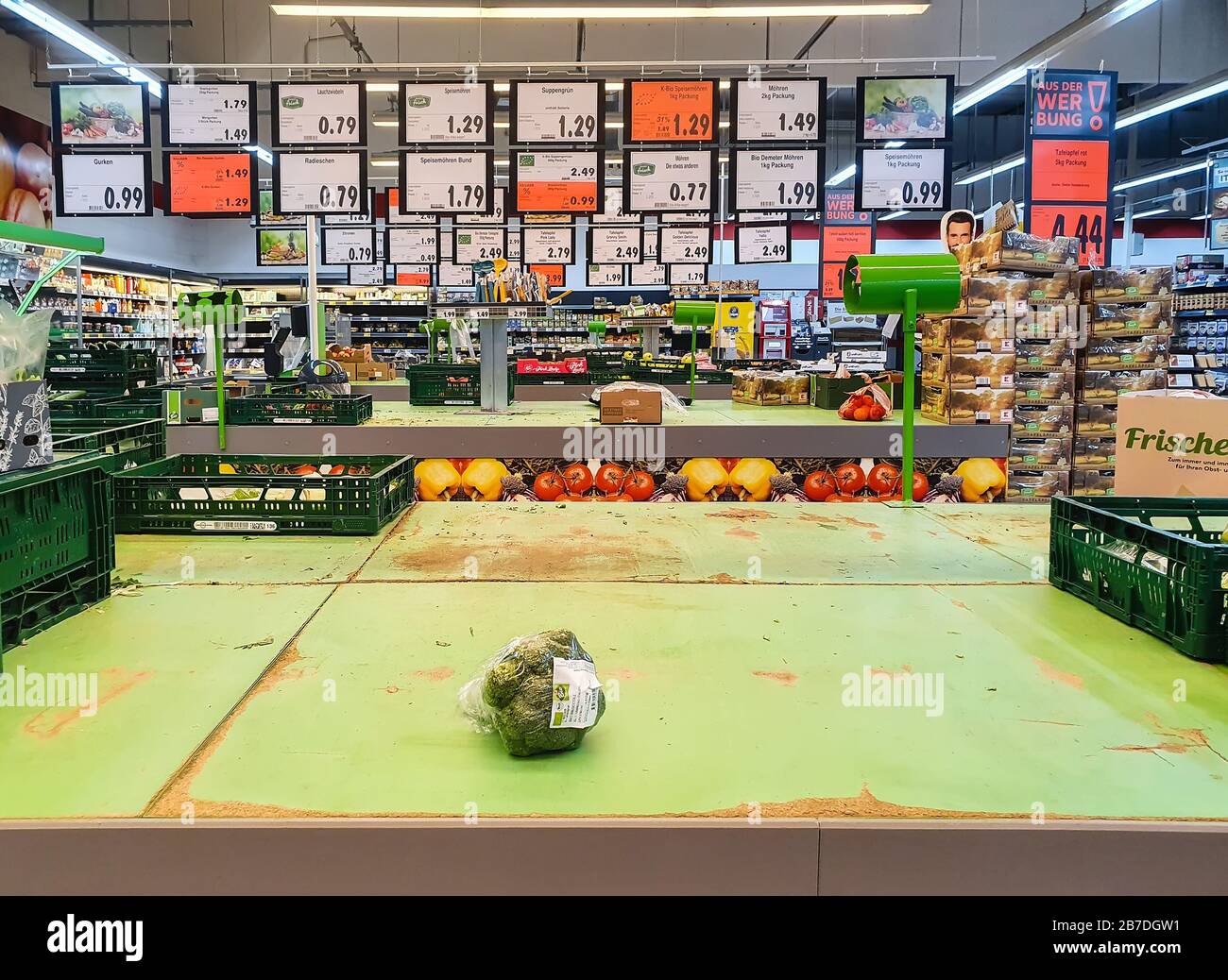 FULDA, GERMANY - MAR 14, 2020: Empty shelves for vegetables with single broccoli at Kaufland supermarket due to Coronavirus crisis. Panic buying leads Stock Photo
