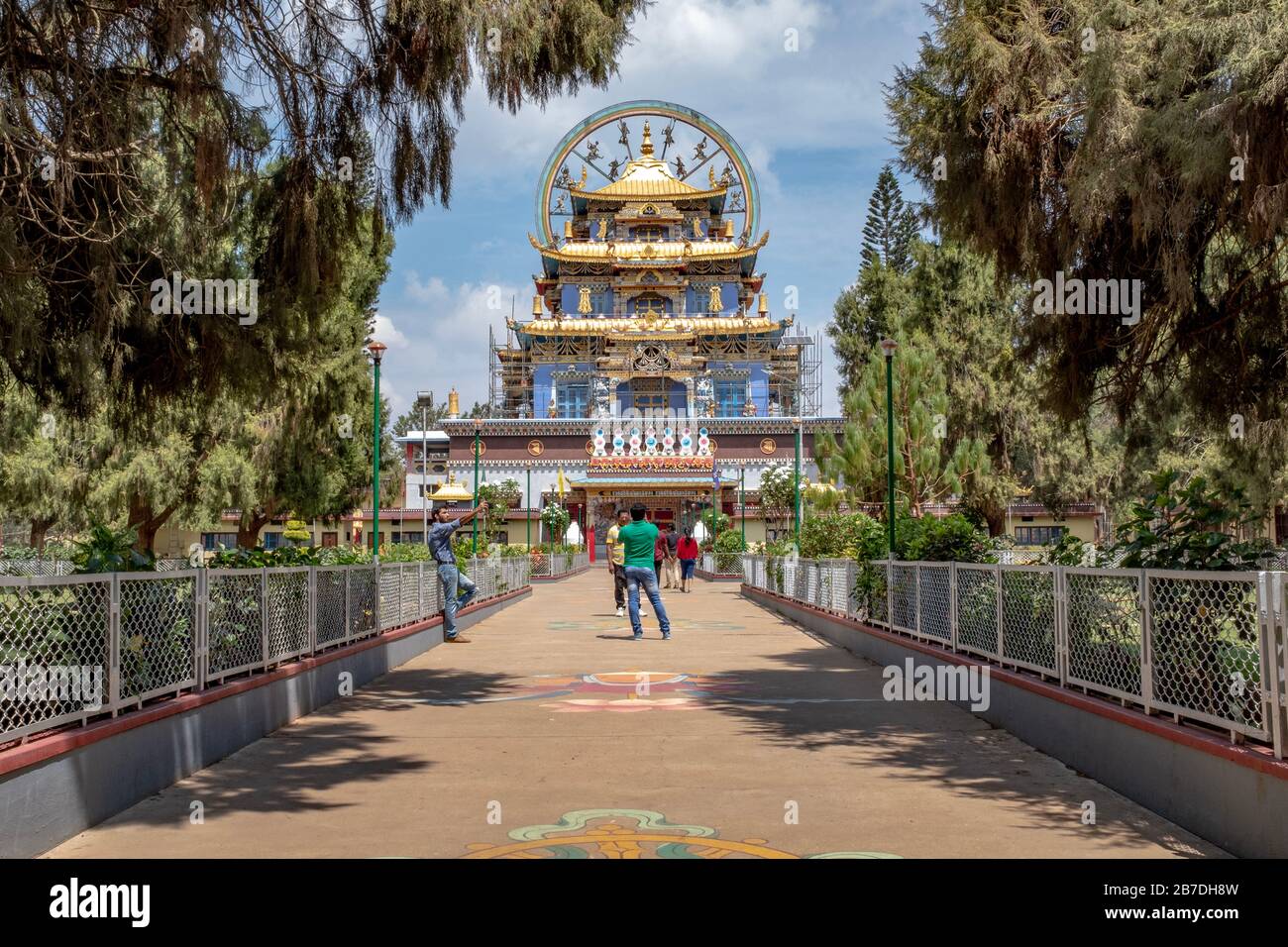 Bylakuppe, Karnataka, India - March 15, 2018: Main entrance of the Namdroling Tibetan, Monastery with some tourists Stock Photo