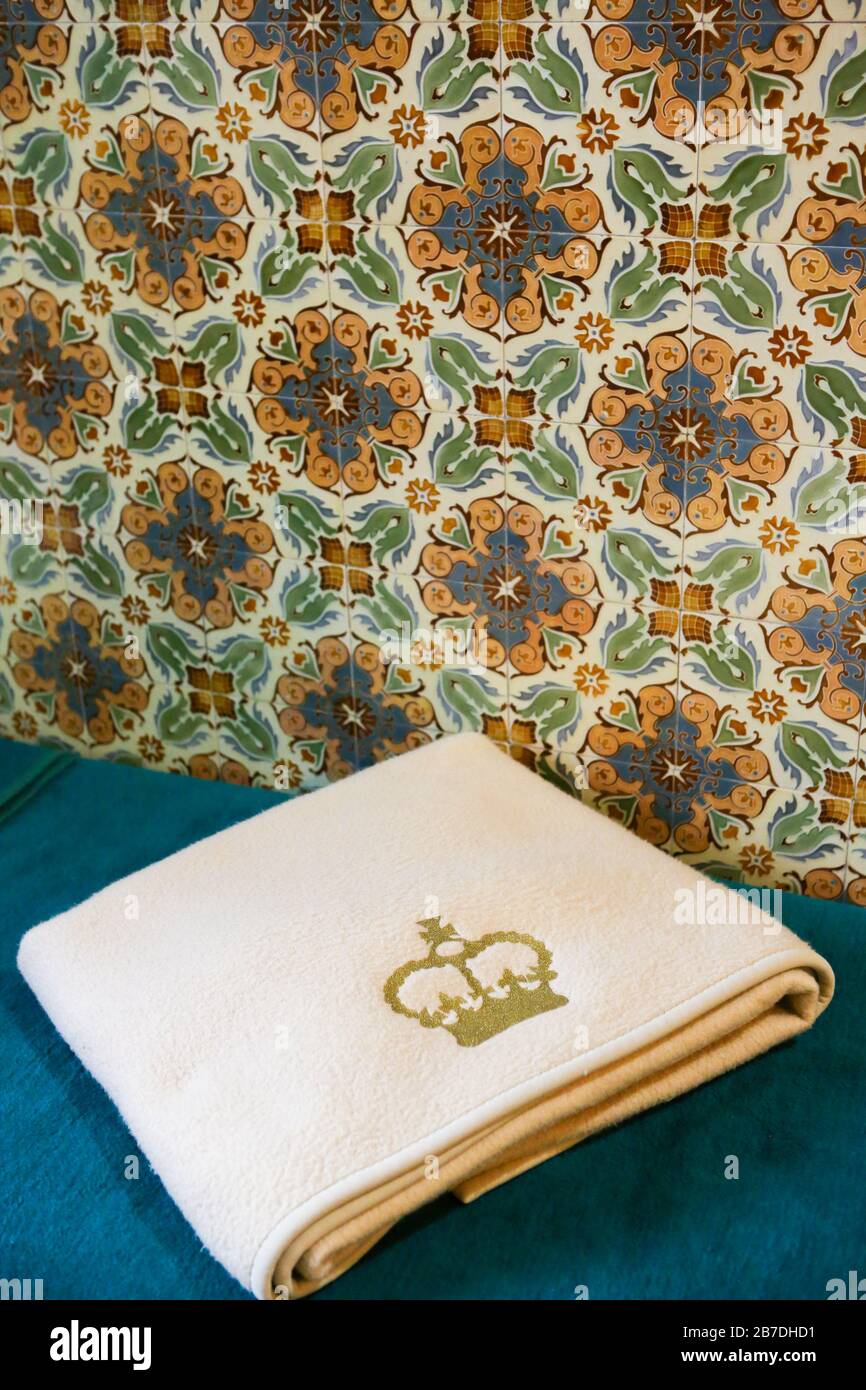 Detail of a towel with a crown and ceramic tiles in a hotel room in Marianske Lazne or Marienbad in Czechia Stock Photo