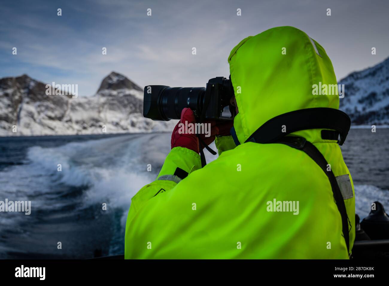 Male photographer capturing the Winter landscape in Senja and Norlandet mountain range, Norway. Stock Photo