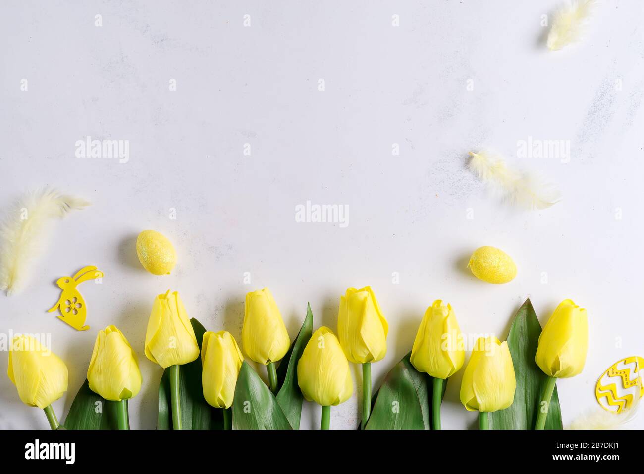 Flat Lay of Easter Eggs with tulips on stone marble background. Easter background or easter concept. Stock Photo