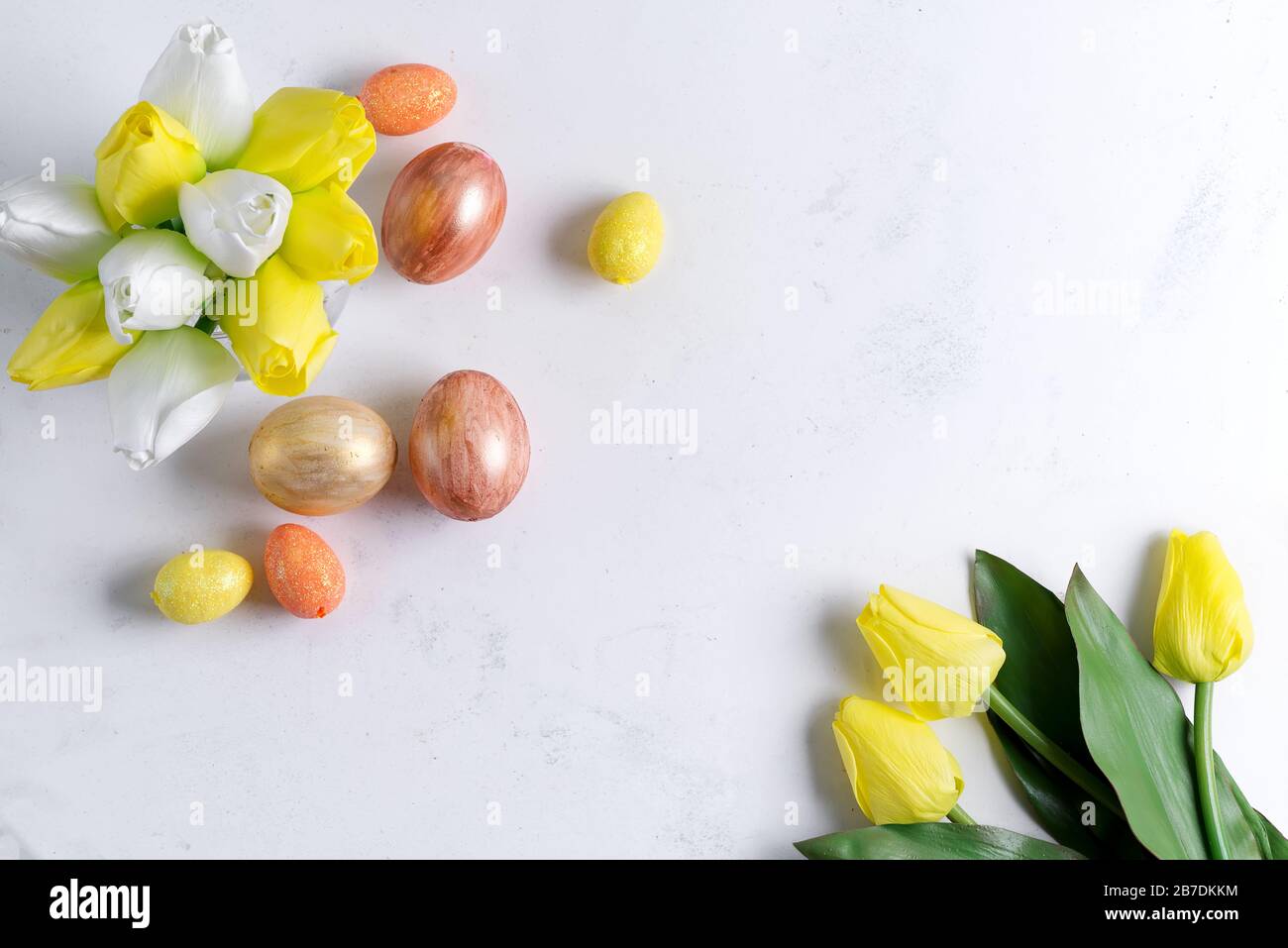 Flat Lay of Golden Easter Eggs with tulips on stone marble background ...