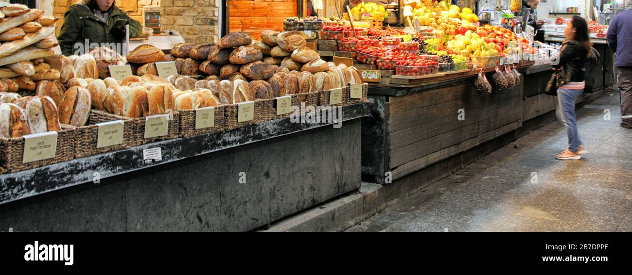 A computer-sized banner shows bread and fresh fruit for sale in the covered market Machane Yehudah in Jerusalem. Stock Photo