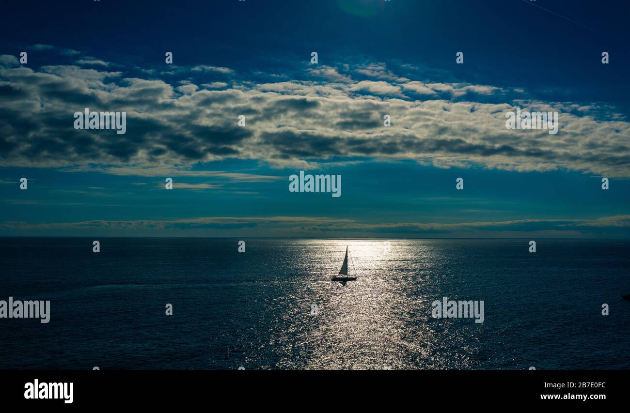 I am sailing into the ocean by my own during sunset Stock Photo