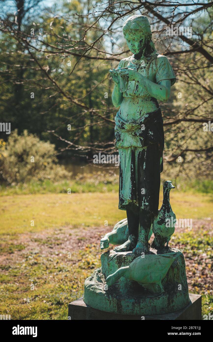 Bronze Statue of the year 1890: The Goose Keeper (La Gardeuse d’oies) by Alphonse De Tombay at the Botanic Garden Meise (National Botanic Garden of Be Stock Photo
