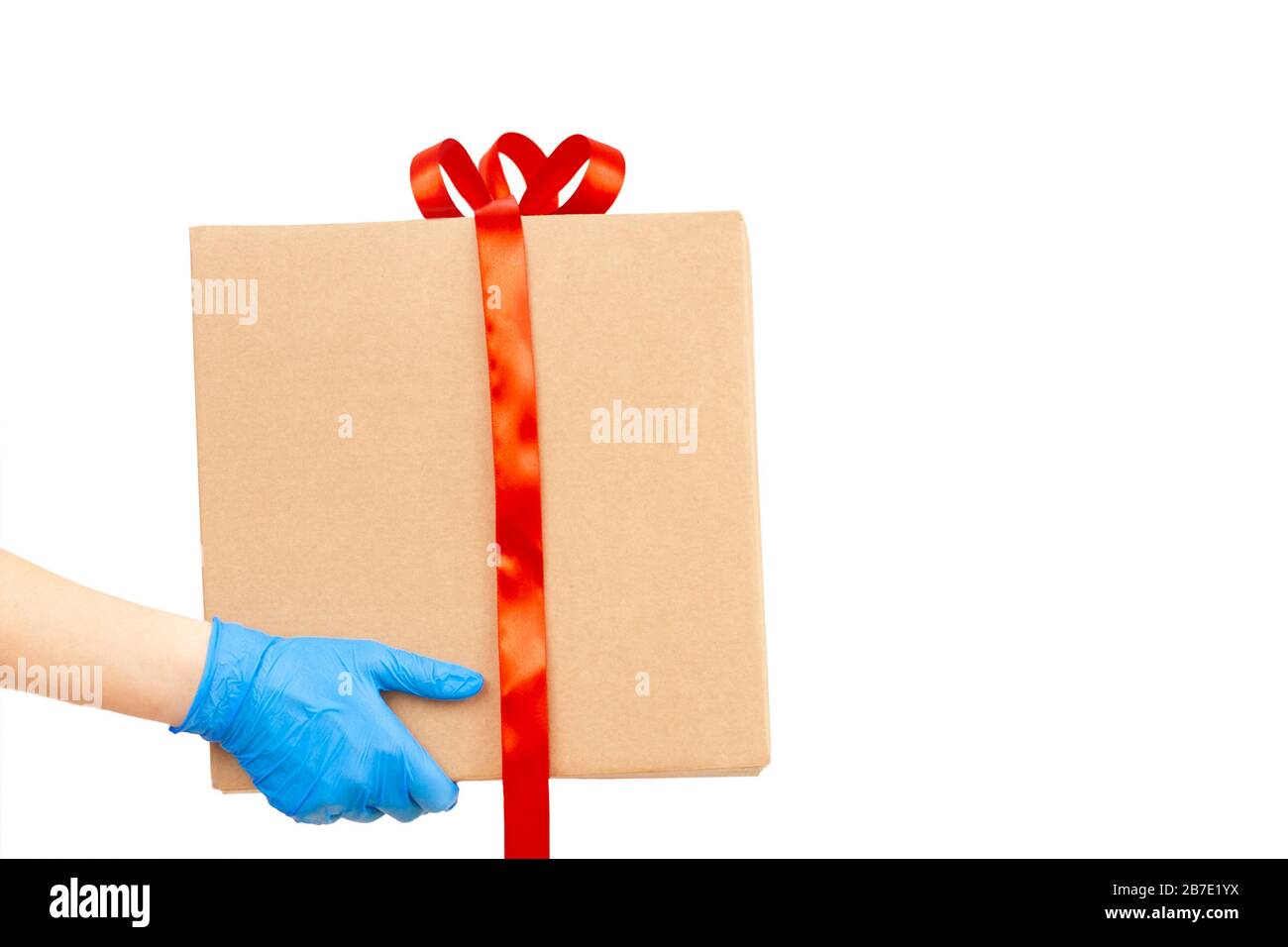 Delivery man holding cardboard boxes / copy space. Delivery by courier in rubber gloves. The shipping time during coronavirus  Stock Photo