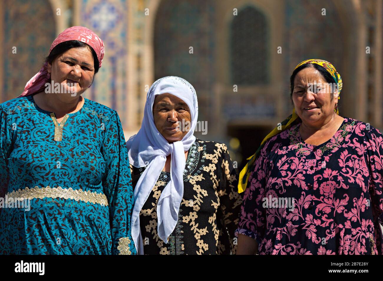 Uzbek ladies in local dress, in the Registan Square, Samarkand, Uzbekistan. Stock Photo