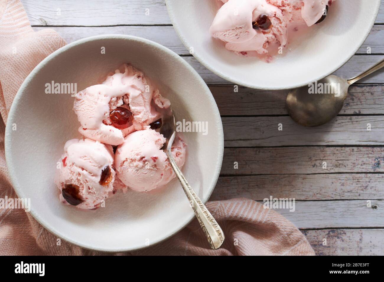 Scoops of cherry ice cream in dessert bowls. Stock Photo